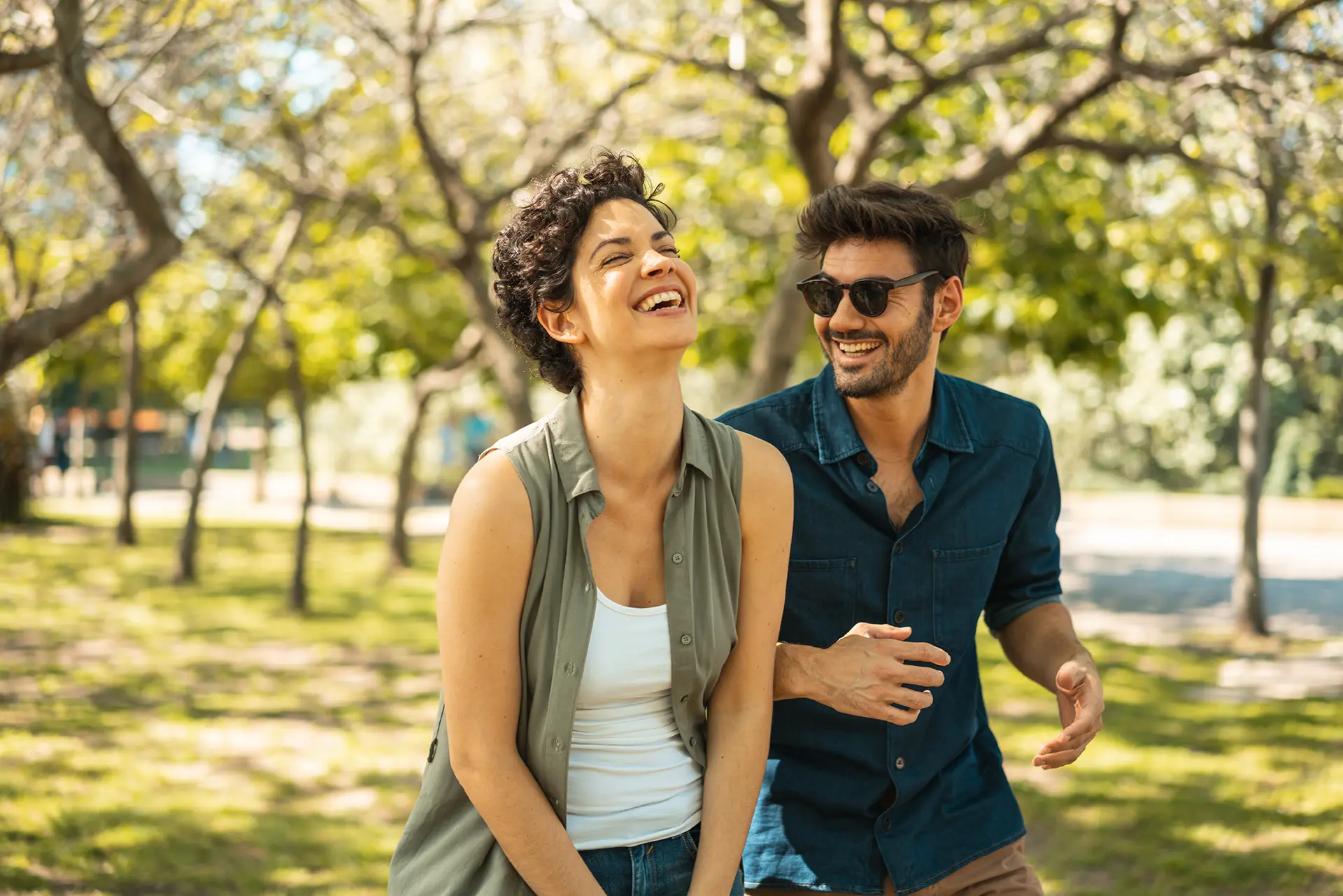 man and woman laughing in the park